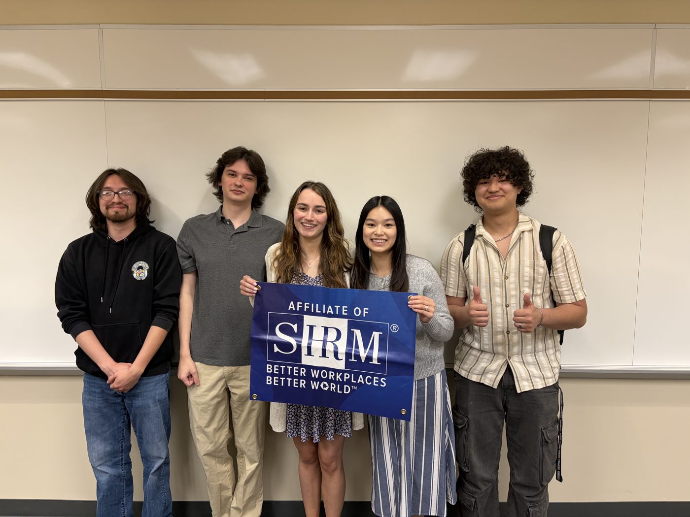 Five members holding the official Affiliate of SHRM banner